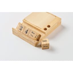 A wooden perpetual calendar with a drawer for date and month blocks, featuring natural wood finish.