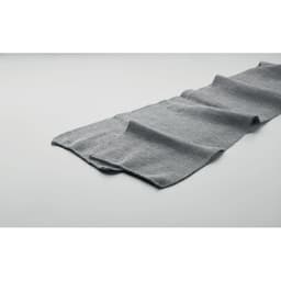 A grey fabric scarf lays flat against a light background, showcasing its soft texture and gentle draping.