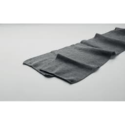 A dark grey scarf laid flat on a light background, featuring a textured fabric and folded design.