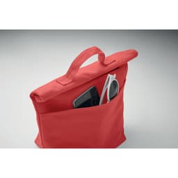 A red tote bag with a pocket, holding a smartphone and sunglasses. The bag features a handle for easy carrying.
