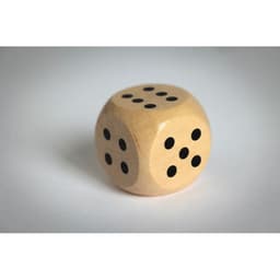 A wooden die with black dots on each face, showing the numbers three, four, and six.