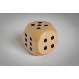A wooden die with black pips on each face, showing numbers one through six.