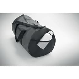 A black duffle bag featuring a drink bottle tucked into a side pocket, with adjustable shoulder strap.