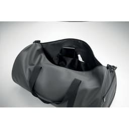 A duffel bag in matte grey with black interior and straps, featuring an inner pocket for a phone.