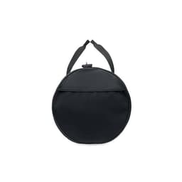 A round black bag with a textured surface and a top strap for carrying. It features a zippered compartment.