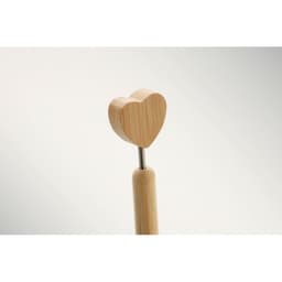 A wooden tool with a heart-shaped top, featuring a light wood finish and a stainless steel handle.