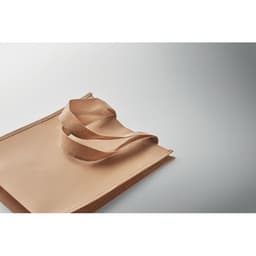 A tote bag in a soft beige colour, featuring two shoulder straps, displayed on a gradient background.