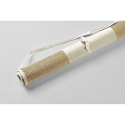 A rolled mat in natural tones, secured with a cream strap, featuring a textured surface.