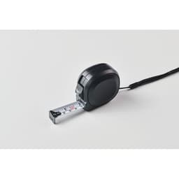 A black measuring tape with a silver retractable tape. It has a logo on the side.