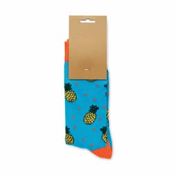 A pair of blue socks featuring pineapple designs and orange accents, packaged with a cardboard tag.