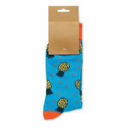 A pair of blue socks featuring pineapple designs and orange accents, attached to a cardboard tag.