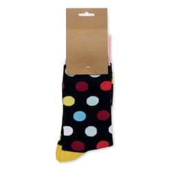 A pair of patterned socks with a black base and colourful polka dots, packaged with a cardboard tag.