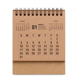 A desk calendar with a spiral binding, featuring months December, January, and February in a simple design.