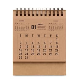 A brown desk calendar featuring the months of December, January, and February, with spiral binding at the top.