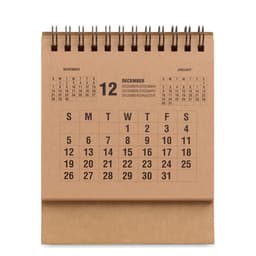 A desk calendar with a brown cover, displaying December's dates and a spiral binding at the top.