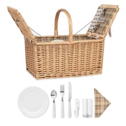 A wicker picnic basket in natural tones with a checkered lining, accompanied by cutlery and plates.