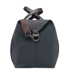 A backpack in a dark grey fabric with brown leather accents and a crossbody strap. It features a zip closure.