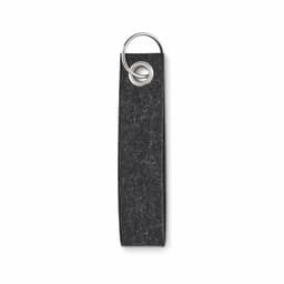 A keychain tag in a dark grey felt material with a metal ring for attachment.