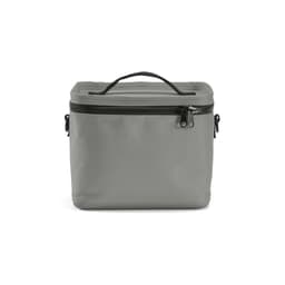 A grey cooler bag with a handle and black thermo-injected zippers. It features a minimalist design with a branding logo.