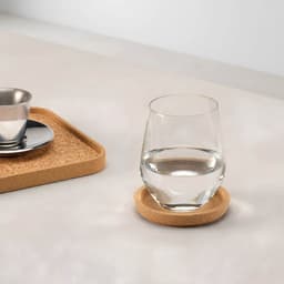A cork coaster with a rim in natural colour, featuring a glass of water and a stainless steel cup on a tray.