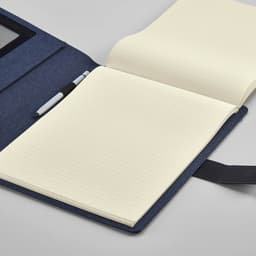 A dark blue folder with a clear pocket and an open notepad featuring lined pages.