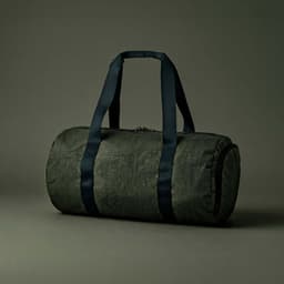 A dark green gym bag with black handles and a cylindrical shape, featuring a zip closure and shoe pocket.
