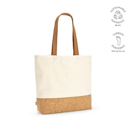 A tote bag featuring a cream cotton upper and a cork bottom, with long brown handles. It includes a logo.