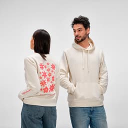 A cream women's crew neck sweatshirt made from organic cotton and rPET, featuring a floral design on the back and a logo.