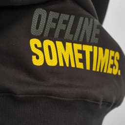 A dark brown sweatshirt with a logo, featuring text that reads "OFFLINE SOMETIMES." in grey and yellow.