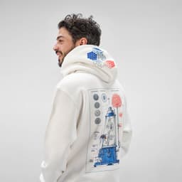 A cream hooded sweatshirt featuring a blue and red graphic design on the back and a branding logo.