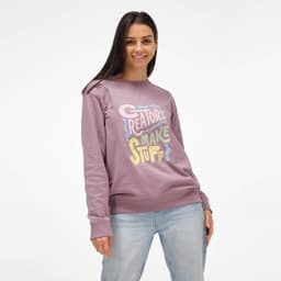 A woman wearing a mauve crew neck sweatshirt made from 100% organic cotton, featuring a colourful graphic design.