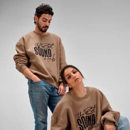 An oversized brown sweatshirt is displayed on two models, featuring a logo on the front.