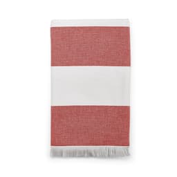 A red and white striped towel with a fringed edge, made of cotton and featuring branding.