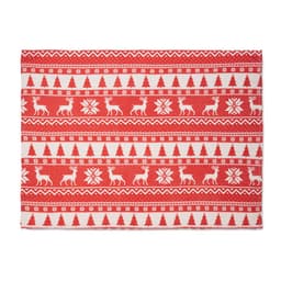 A festive red and white patterned table runner featuring reindeer, trees, and snowflakes in a Christmas design.
