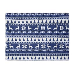 A decorative rug featuring a navy blue and white pattern with reindeer, trees, and snowflakes.