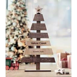 A decorative wooden Christmas tree featuring multiple layered segments and a star on top, with a logo included.