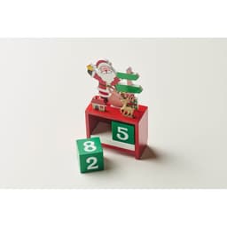 A red display stand featuring Santa Claus and a reindeer, with green numbered blocks showing 8, 2, and 5.