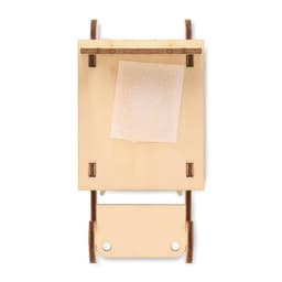 A wooden sleigh model with a simple design, featuring a flat surface and a small fabric piece attached.