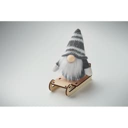 A decorative gnome with a grey striped hat sits on a wooden sleigh, featuring a beard and round nose.