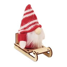 A decorative gnome with a striped red hat sitting on a wooden sleigh. Features white beard and felt accents.