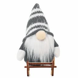 A decorative gnome figurine with a grey knitted hat and white beard, standing on a small wooden sled.