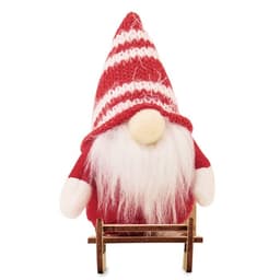 A decorative gnome figure in a red and white striped hat, with a white beard and a wooden sled base.