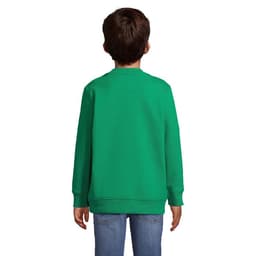 A green sweatshirt is worn by a child, viewed from the back, paired with blue jeans. The item features a logo on the back.