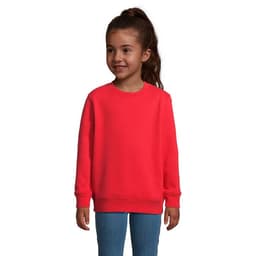 A red sweatshirt for kids displayed on a smiling child, featuring a round neck and long sleeves.