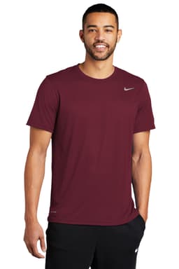 A maroon Nike Team rLegend Tee featuring a logo, worn by a man. The shirt has short sleeves and a crew neckline.