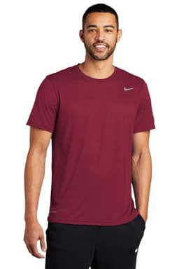 A maroon Nike Team rLegend Tee with a logo, worn by a model. The shirt features a classic crew neck and short sleeves.