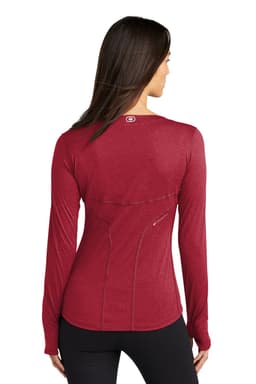 A red long sleeve crew shirt with a fitted design, featuring a logo on the back and a zip pocket.