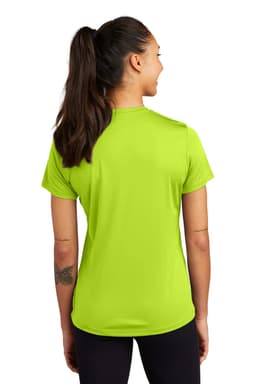 A woman is wearing a bright lime green Sport-Tek PosiCharge Competitor Tee, viewed from the back.