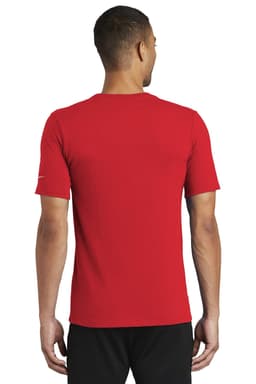 A red Nike Dri-FIT Cotton/Poly Tee displayed on a model from the back, featuring a logo on the sleeve.