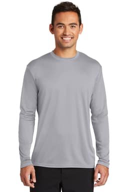 A long sleeve performance tee in grey, featuring a logo, modelled by a smiling man.